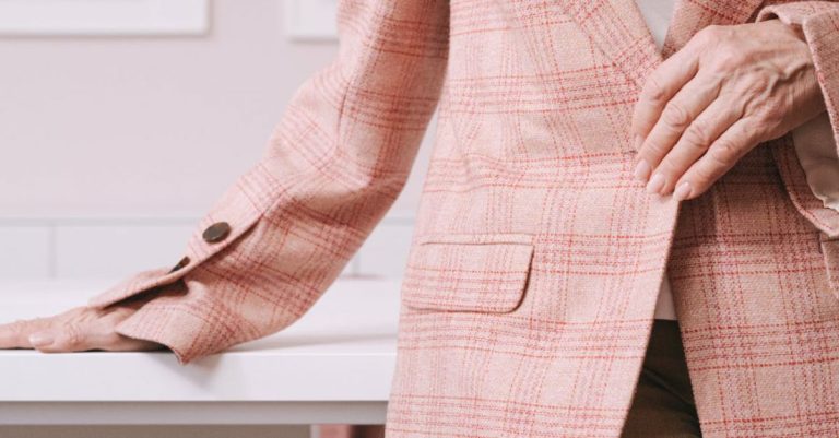 Remotely - Woman in Pink and White Plaid Blazer Sitting on Brown Wooden Chair