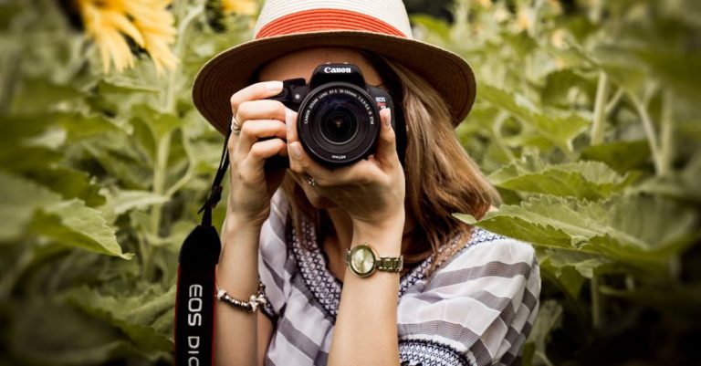 Photography - Selective Focus Photography of Woman Holding Dslr Camera