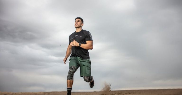 Fitness - Man Running on Sand Field