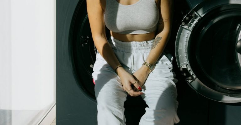 Laundry - Young woman leaning on washing machine