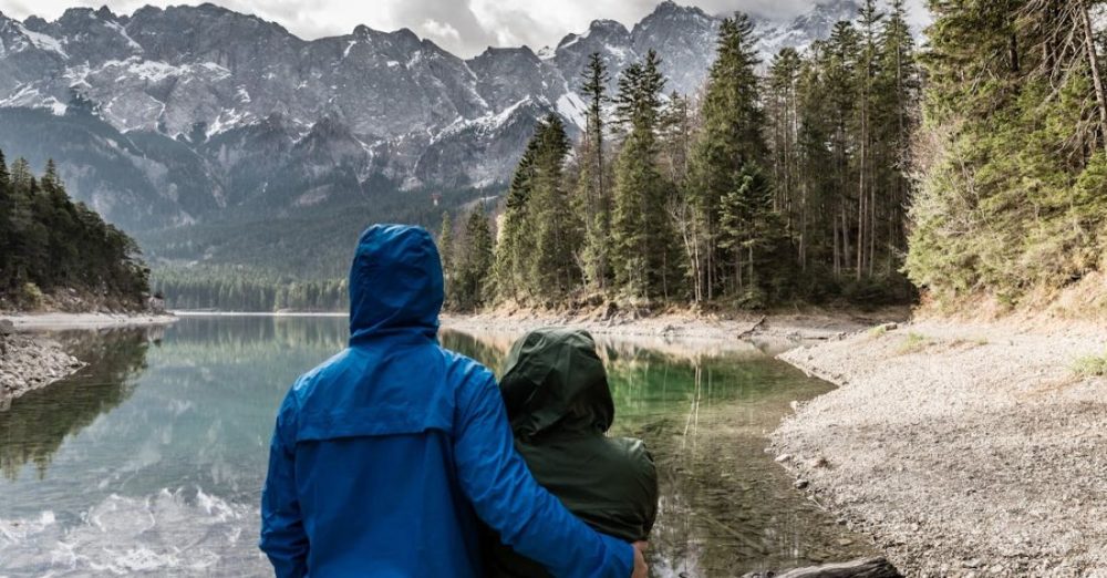 Travelers - Couple Standing Near Body of Water