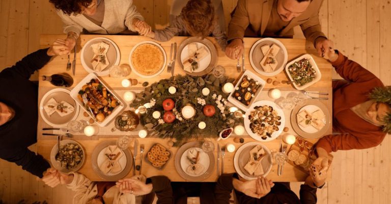 Dining Areas - Top View of a Family Praying Before Christmas Dinner